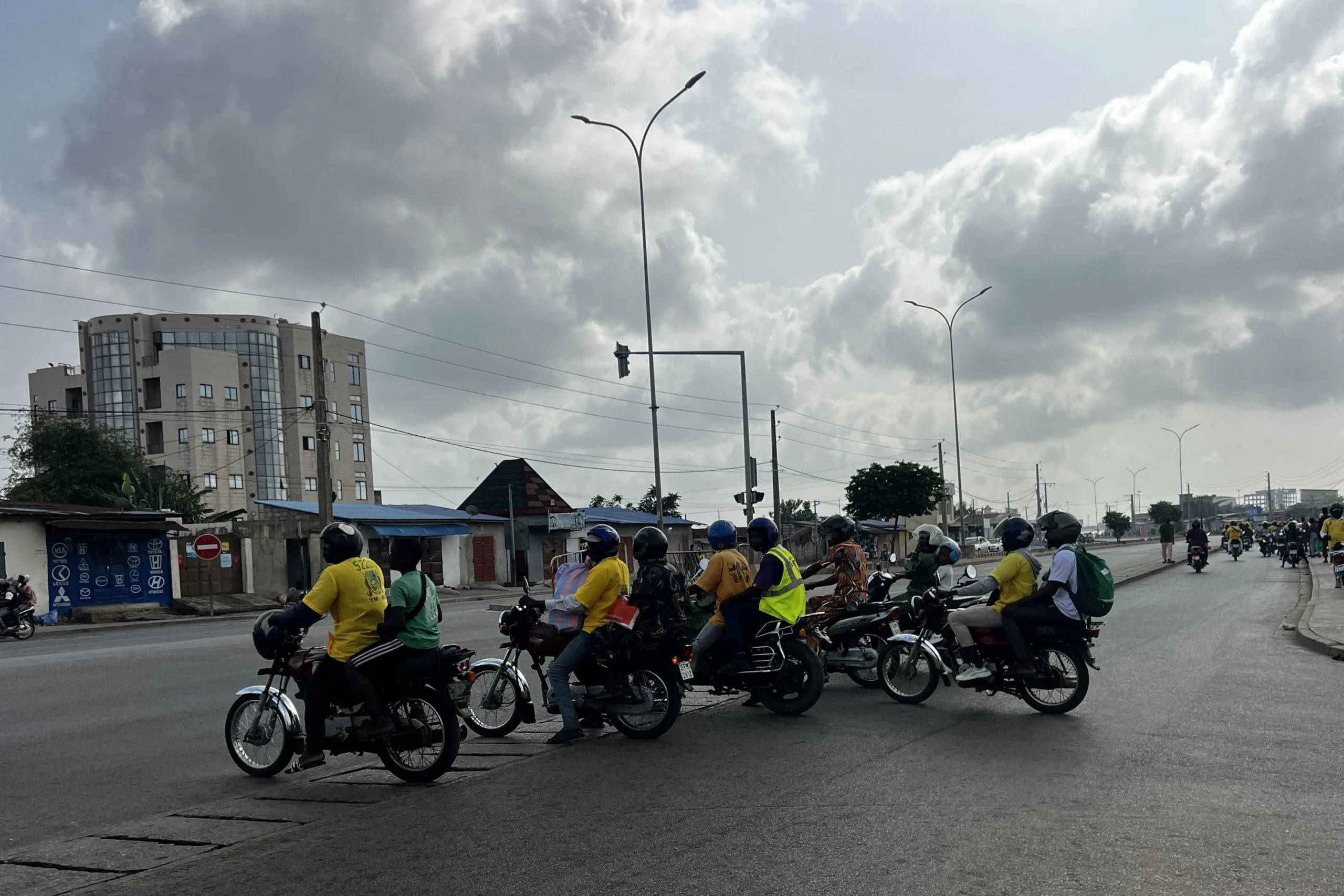 Motos-taxis transportant des passagers à Cotonou dans un contexte de rumeurs de coup d'État